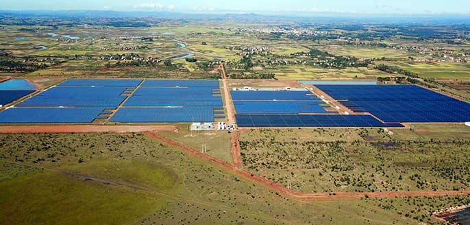 Solar panels on field seen from afar
